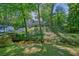 Home with gray siding, surrounded by trees, with a river in front at 2162 Brookview Nw Dr, Atlanta, GA 30318