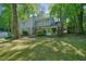 Attractive front yard features stone accents, a red door, and mature landscaping at 2162 Brookview Nw Dr, Atlanta, GA 30318
