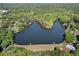 Scenic aerial view of a lake surrounded by lush green trees, community pool and residential properties at 3255 Sutcliffe Nw Rdg, Marietta, GA 30064