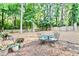 Large backyard with dining set and mature trees, perfect for outdoor entertaining and relaxation at 3255 Sutcliffe Nw Rdg, Marietta, GA 30064