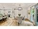 Dining area with a modern light fixture, sliding barn door, and kitchen in the background at 3255 Sutcliffe Nw Rdg, Marietta, GA 30064