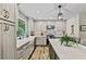 Bright kitchen with stainless appliances, shaker cabinets, long island, farmhouse sink, and modern lighting at 3255 Sutcliffe Nw Rdg, Marietta, GA 30064