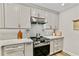 Close up of the updated kitchen with stainless steel appliances, tile backsplash, and shaker style cabinets at 3255 Sutcliffe Nw Rdg, Marietta, GA 30064