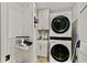 Efficient laundry room equipped with stacked washer/dryer and utility sink at 3255 Sutcliffe Nw Rdg, Marietta, GA 30064