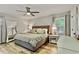 Comfortable main bedroom with neutral tones, ceiling fan, ensuite bath, and a full-length mirror at 3255 Sutcliffe Nw Rdg, Marietta, GA 30064