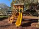Community playground featuring a wooden structure with a yellow slide for outdoor fun at 3255 Sutcliffe Nw Rdg, Marietta, GA 30064