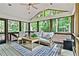 Beautiful screened porch with wood furniture, ceiling fan, and large windows overlooking the wooded backyard at 3255 Sutcliffe Nw Rdg, Marietta, GA 30064