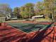 Well-maintained community tennis courts with surrounding trees and glimpses of nearby houses at 3255 Sutcliffe Nw Rdg, Marietta, GA 30064