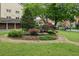 Well-maintained courtyard landscaping with stone benches, a maple tree, and a grassy area at 1634 Ponce De Leon Ne Ave # 208, Atlanta, GA 30307