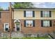 Charming brick townhome featuring black shutters and a covered front entry, offering classic appeal at 1634 Ponce De Leon Ne Ave # 208, Atlanta, GA 30307