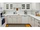 All-white kitchen with white cabinetry and a complementary white tiled backsplash at 1634 Ponce De Leon Ne Ave # 208, Atlanta, GA 30307
