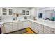 Updated kitchen with white cabinets, marble countertops, stainless steel appliances, and hardwood floors at 1634 Ponce De Leon Ne Ave # 208, Atlanta, GA 30307