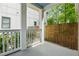 Cozy covered back porch with white columns and wood fence at 183 Whitefoord Ne Ave, Atlanta, GA 30307
