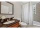 Bathroom features granite counter, decorative mirror, and shower with glass block window at 183 Whitefoord Ne Ave, Atlanta, GA 30307
