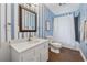 Bathroom features striped wallpaper, framed mirror and shower with curtain at 183 Whitefoord Ne Ave, Atlanta, GA 30307