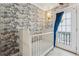 Bright Bedroom features a crib with wallpaper accent and french doors to exterior at 183 Whitefoord Ne Ave, Atlanta, GA 30307