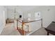 Carpeted hallway overlooking the living room, and bright natural light at 183 Whitefoord Ne Ave, Atlanta, GA 30307