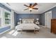 Spacious bedroom with blue walls, ceiling fan, and an abundance of natural light at 183 Whitefoord Ne Ave, Atlanta, GA 30307