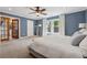 Spacious bedroom with blue walls, ceiling fan, and access to the closets at 183 Whitefoord Ne Ave, Atlanta, GA 30307