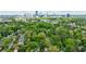 Aerial view of a neighborhood with lush green trees and a cityscape in the distance at 2840 Alpine Rd, Atlanta, GA 30305
