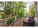Inviting wood deck with outdoor seating and views of the lush, mature landscaping and trees at 2840 Alpine Rd, Atlanta, GA 30305