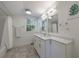 Bright bathroom with double sinks, a window, and white cabinets at 2840 Alpine Rd, Atlanta, GA 30305