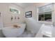 Serene bathroom featuring a freestanding tub, stylish patterned floor tiles, and ample natural light at 2840 Alpine Rd, Atlanta, GA 30305