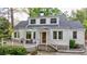 Charming two-story white home with a welcoming front porch, stone accents, and lush landscaping at 2840 Alpine Rd, Atlanta, GA 30305