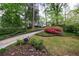 Beautifully landscaped front yard with a long driveway, mature trees, and blooming azaleas at 2840 Alpine Rd, Atlanta, GA 30305