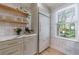 Bright kitchen featuring stainless steel appliances, floating wood shelves, and lots of storage at 2840 Alpine Rd, Atlanta, GA 30305
