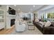 Bright, open-concept living room with fireplace, hardwood floors, and views to the kitchen at 2840 Alpine Rd, Atlanta, GA 30305
