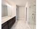 Bathroom with marble floors, dual sinks, and a glass shower at 4090 Cavalier Way, Duluth, GA 30097