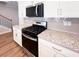 Modern kitchen with stainless steel gas range, granite counters and sleek white cabinets at 4090 Cavalier Way, Duluth, GA 30097