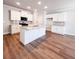 Spacious kitchen with white cabinets, stainless steel appliances, and a large center island at 4090 Cavalier Way, Duluth, GA 30097