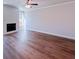 Bright living room featuring a fireplace, light hardwood floors and modern ceiling fan at 4090 Cavalier Way, Duluth, GA 30097