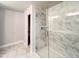 Shower with marble tiling, rainfall shower head, and glass door at 4090 Cavalier Way, Duluth, GA 30097