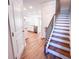 View of a bright kitchen adjacent to a wood and wrought iron staircase at 4090 Cavalier Way, Duluth, GA 30097