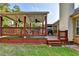A covered deck with ceiling fans for outdoor relaxation and a well-manicured lawn offer ample space at 755 James Ridge Dr, Lawrenceville, GA 30045