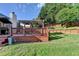 View of a lovely backyard featuring a well-kept lawn and inviting deck area with a covered pergola for outdoor relaxation at 755 James Ridge Dr, Lawrenceville, GA 30045