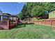Expansive backyard showcasing a deck with a pergola and a landscaped terraced garden for outdoor enjoyment at 755 James Ridge Dr, Lawrenceville, GA 30045