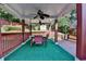 Backyard deck with covered dining area, ceiling fans, gas heater, and wooden fence at 755 James Ridge Dr, Lawrenceville, GA 30045