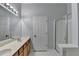Bathroom featuring a dual sink vanity, mirror, and a glass enclosed shower at 755 James Ridge Dr, Lawrenceville, GA 30045