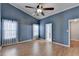 Spacious bedroom featuring vaulted ceiling, a ceiling fan, wood floors, and two windows at 755 James Ridge Dr, Lawrenceville, GA 30045