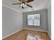 Bright bedroom with ceiling fan, window, and neutral walls at 755 James Ridge Dr, Lawrenceville, GA 30045