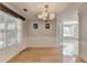 Formal dining room with hardwood floors, decorative chandelier, wainscoting and lots of natural light at 755 James Ridge Dr, Lawrenceville, GA 30045