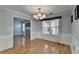 Bright dining room with hardwood floors, modern chandelier, and large window for natural light at 755 James Ridge Dr, Lawrenceville, GA 30045