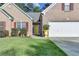 A closer look at the charming brick home with a two-car garage and bright yellow front door at 755 James Ridge Dr, Lawrenceville, GA 30045