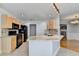 Open kitchen with granite counters, black appliances and view to dining area at 755 James Ridge Dr, Lawrenceville, GA 30045