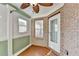 Charming sunroom with brick accent wall, tile floor, and a door to the outdoors at 755 James Ridge Dr, Lawrenceville, GA 30045