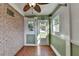 Inviting sunroom featuring brick accent wall, tile floor, ceiling fan and multiple windows for natural light at 755 James Ridge Dr, Lawrenceville, GA 30045